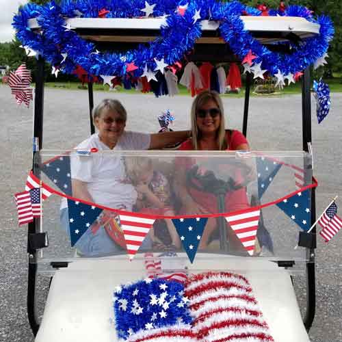 nola-on-golf-cart-whispering-river-resort